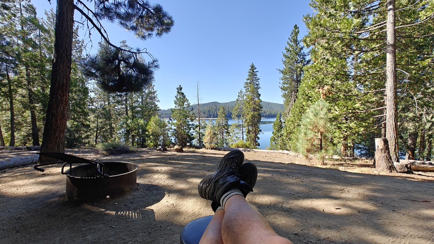 Feet up by the fire ring overlooking Union Valley Reservoir while camping